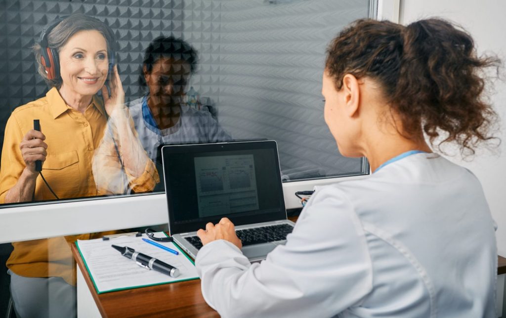 Receptionist at a hearing clinic attending to clients